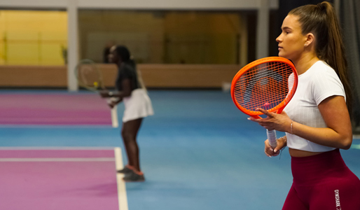 Image of women playing tennis on indoor courts at David Lloyd Clubs