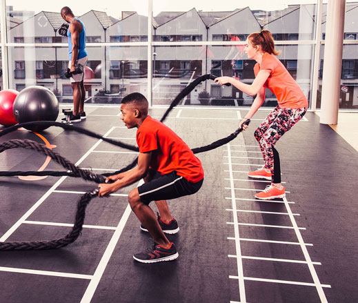 Image of teenagers using the battle ropes in the gym