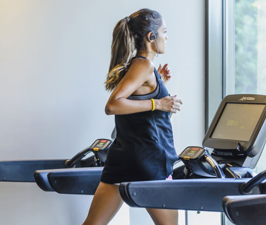 Image of lady running on treadmill in gym